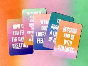 multiple multicolored cards. Top card says Describe and be with stillness