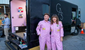 pink jumpsuits, next to Gas