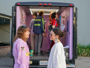 Visitors to common survival, in back of Gas, pink jumpsuit