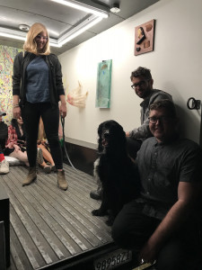 gallery visitors sitting inside Gas, with dog