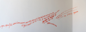 Red text hand drawn on white walls