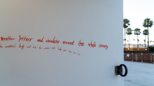 Red text hand drawn on white walls: written letters and circulates around the whole energy